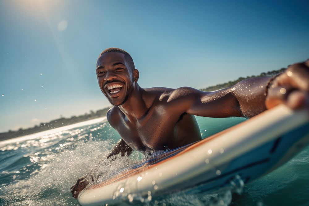 African man sea swimming laughing.