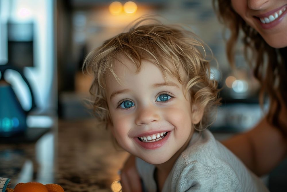 Happy british kid with mom portrait laughing teeth.