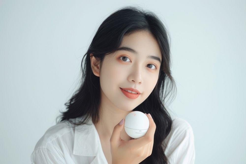 South east asian woman holding cosmetic product portrait photo photography.