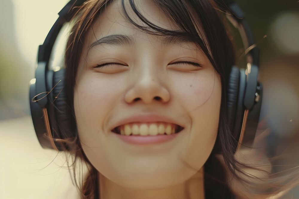 Extreme close up of Cheerful asian person listening to music headphones cheerful headset.