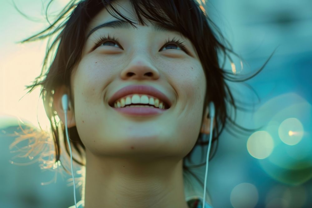 Extreme close up of Cheerful asian person listening to music laughing cheerful smile.