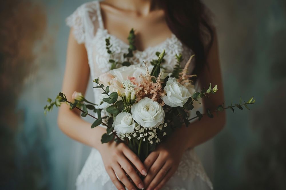 Bride holding flowers fashion wedding dress.