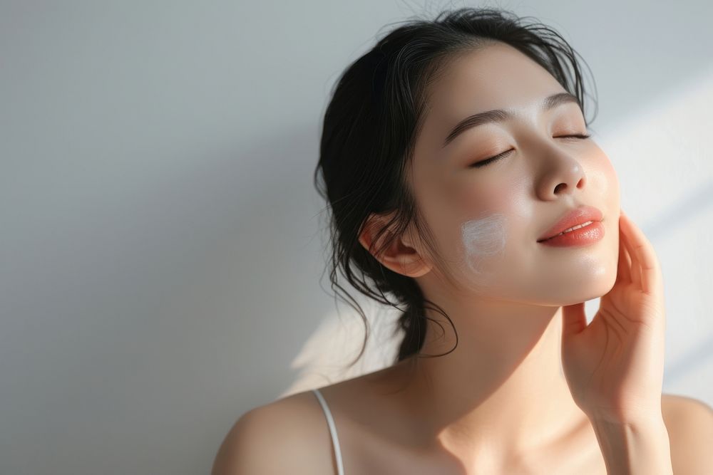 Singaporean woman doing skincare routine adult contemplation relaxation.