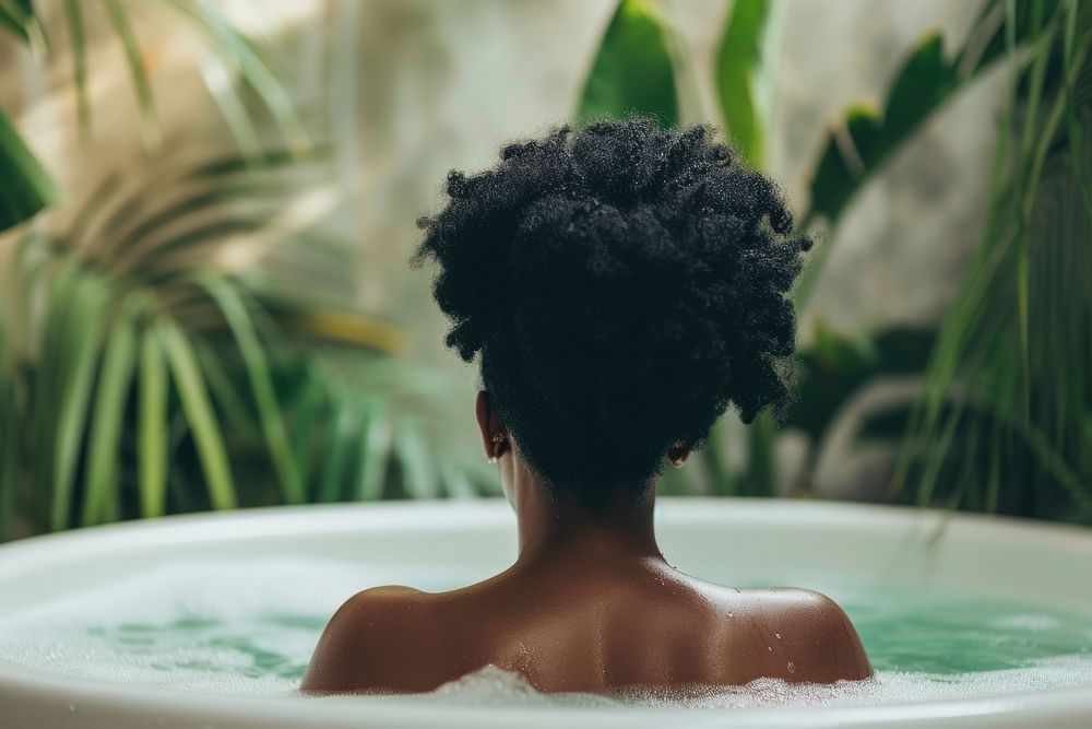 Photo of black woman in large tub back relaxation hairstyle.