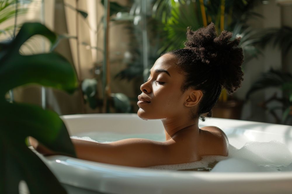 Photo of black woman in large tub bathtub contemplation relaxation.