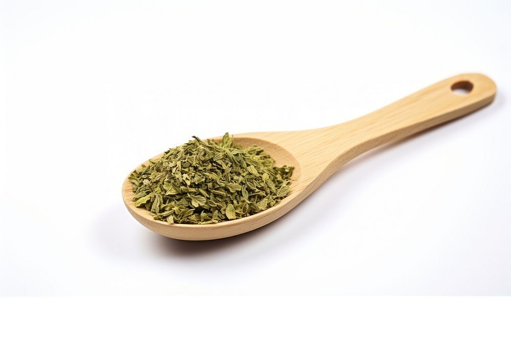 Dried oregano chopped on wooden spoon food ingredient freshness.