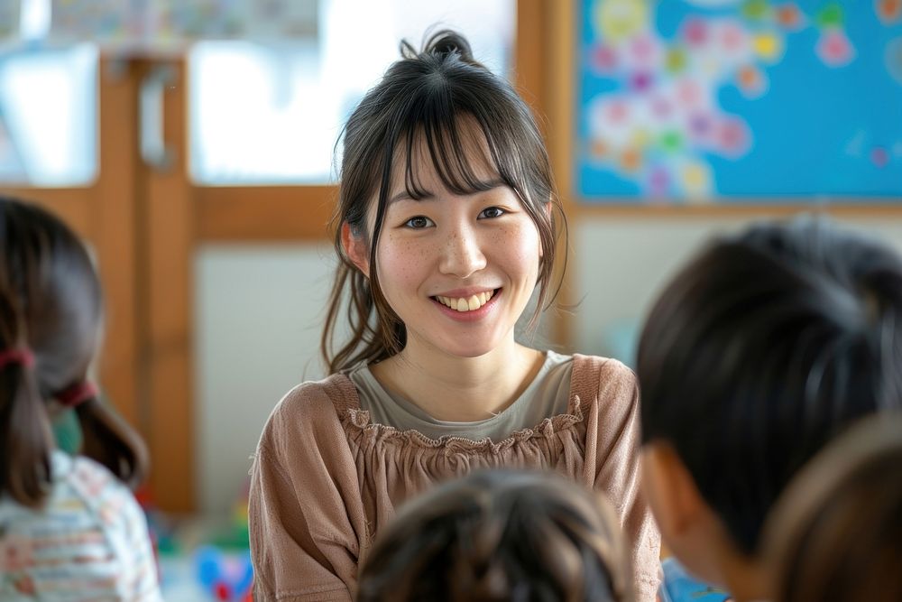Japan teacher teaching a classroom of students child smile happy.