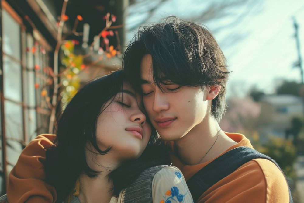 Photo of Japanese teenager couple portrait kissing happy.