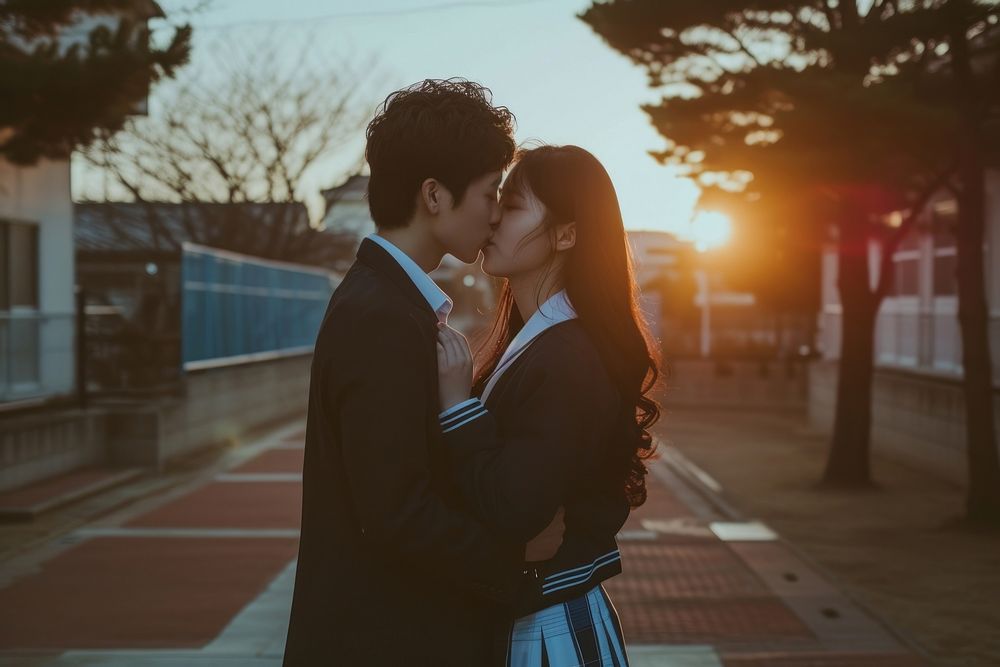 Photo of korean highschool student couple kissing outdoors adult love.