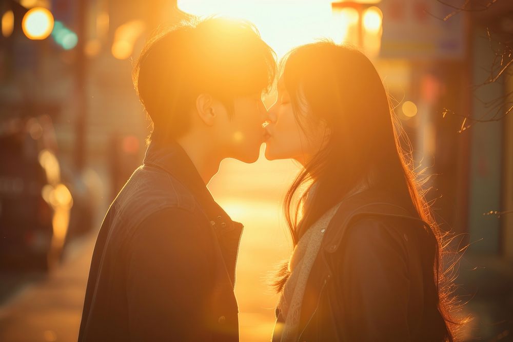 Photo of korean young adult couple kissing portrait outdoors love.