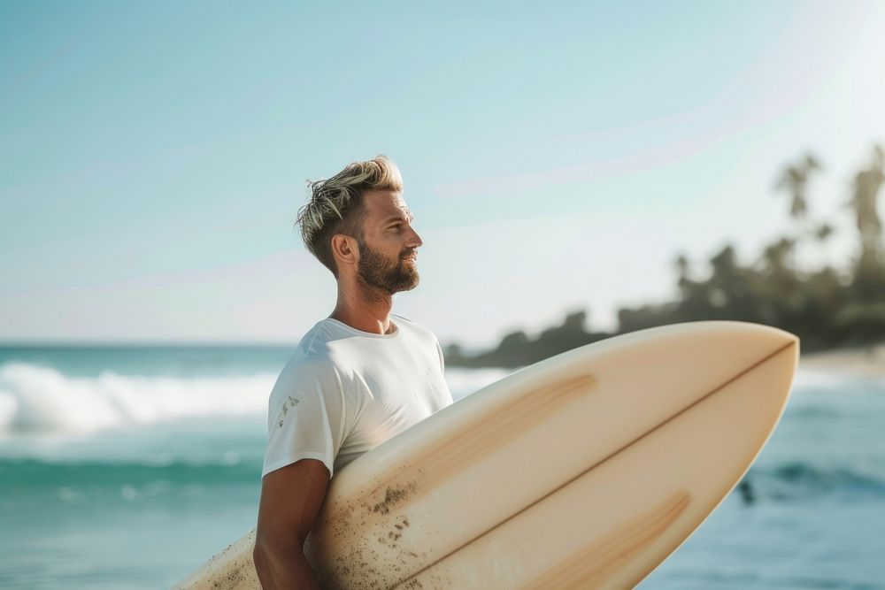 Man holding a surf board outdoors recreation surfing.