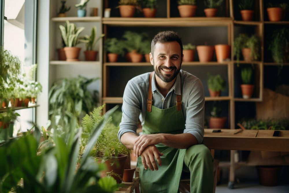 Man sit on a chair in front of shelf of potted plant gardening sitting nature.