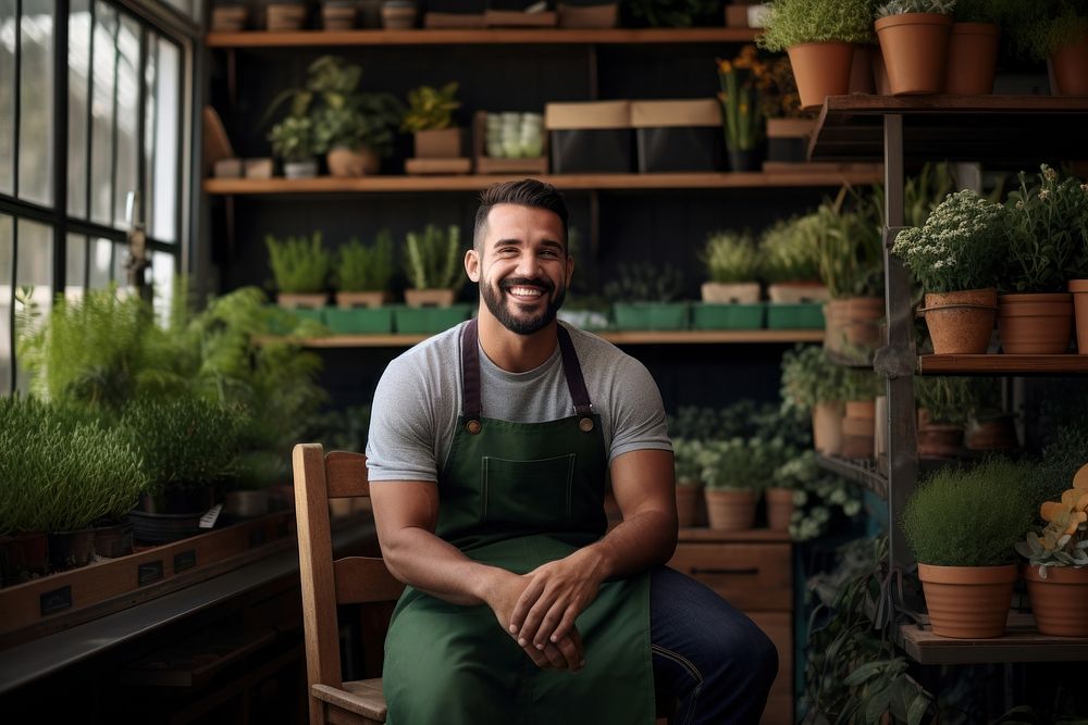 Man sit on a chair in front of shelf of potted plant gardening nature person.