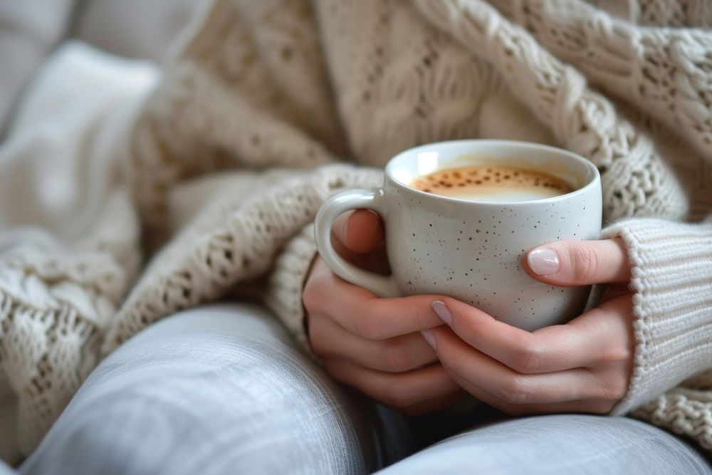 Photo of person with coffee on sofa drink cup mug.