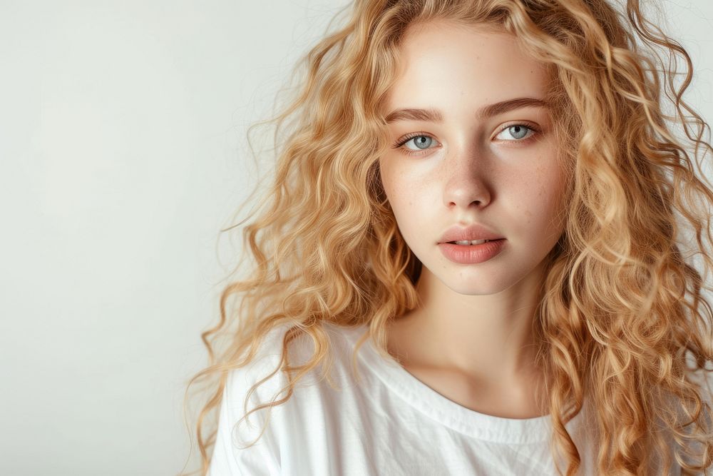 European young woman with blonde long coily hair portrait photography white.