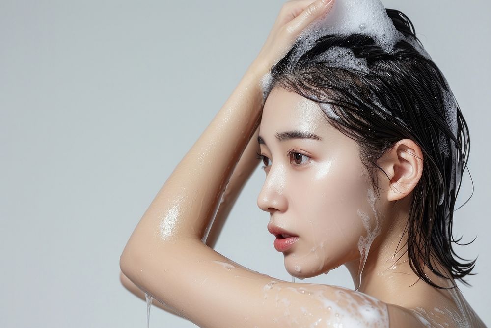 Korean woman washing hair with shampoo portrait bathing fashion.