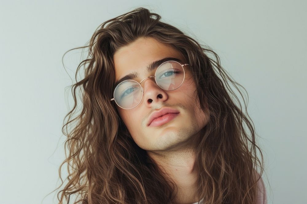 Young man with long wavy hair portrait glasses photography.