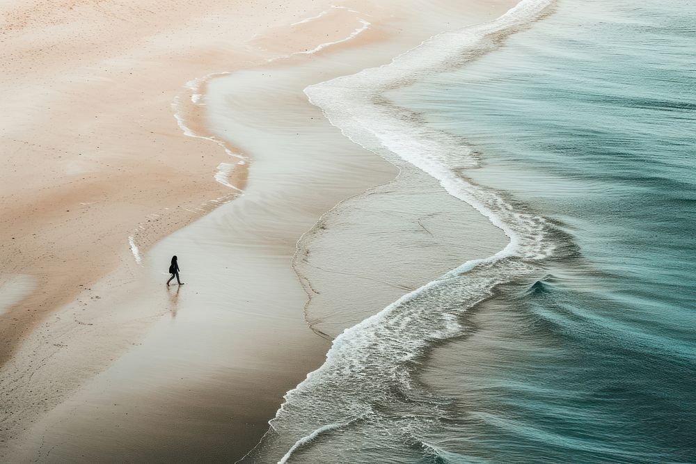 Person walking beach outdoors nature.