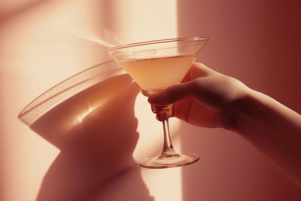 Hand holding cocktail glass martini drink adult.