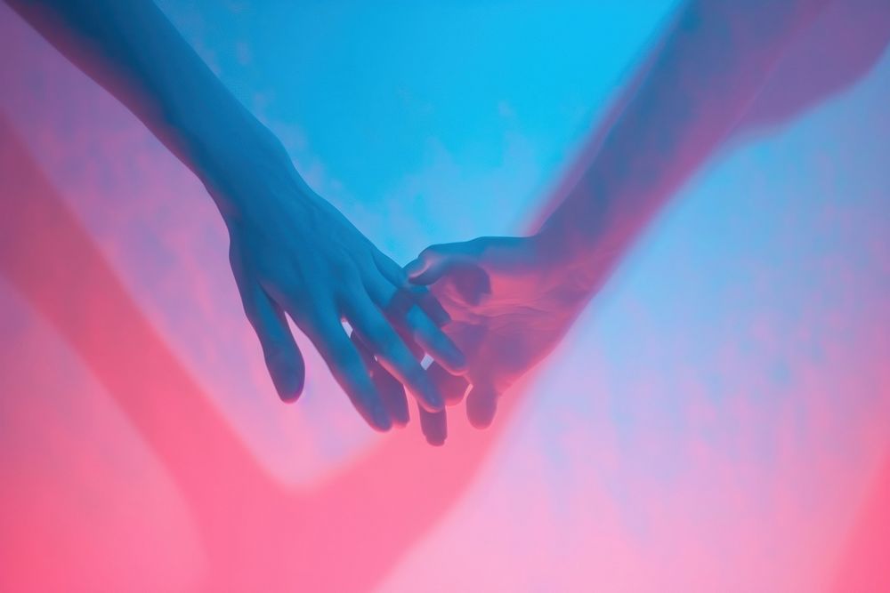 Two hand holding blue pink red.