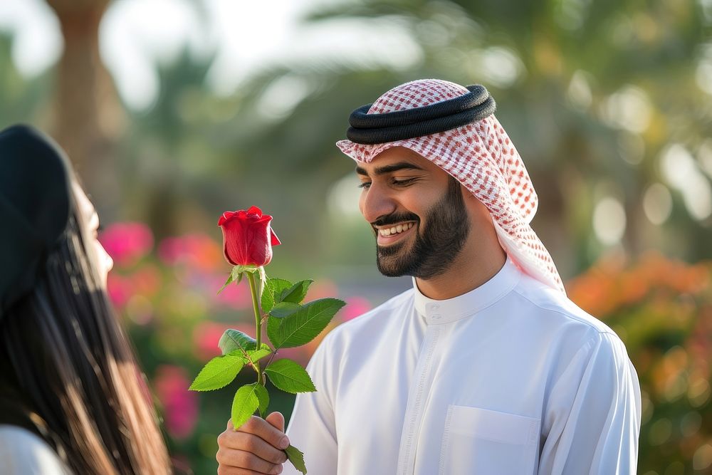 Middle eastern man giving rose to his girl friens smiling flower adult.