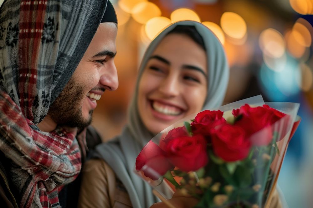 Middle eastern man giving roses bouquet to his girl friend smiling adult love.