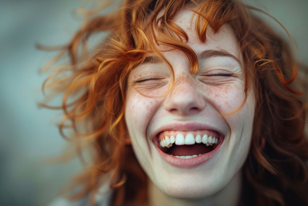 British woman laughing smile eyes closed.