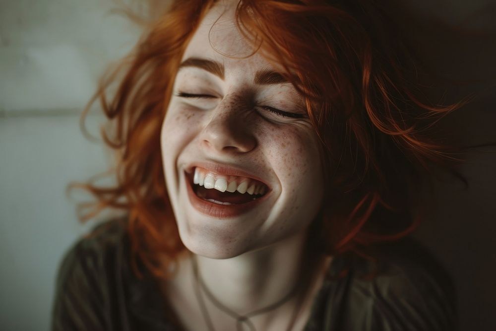 British woman laughing adult eyes closed.