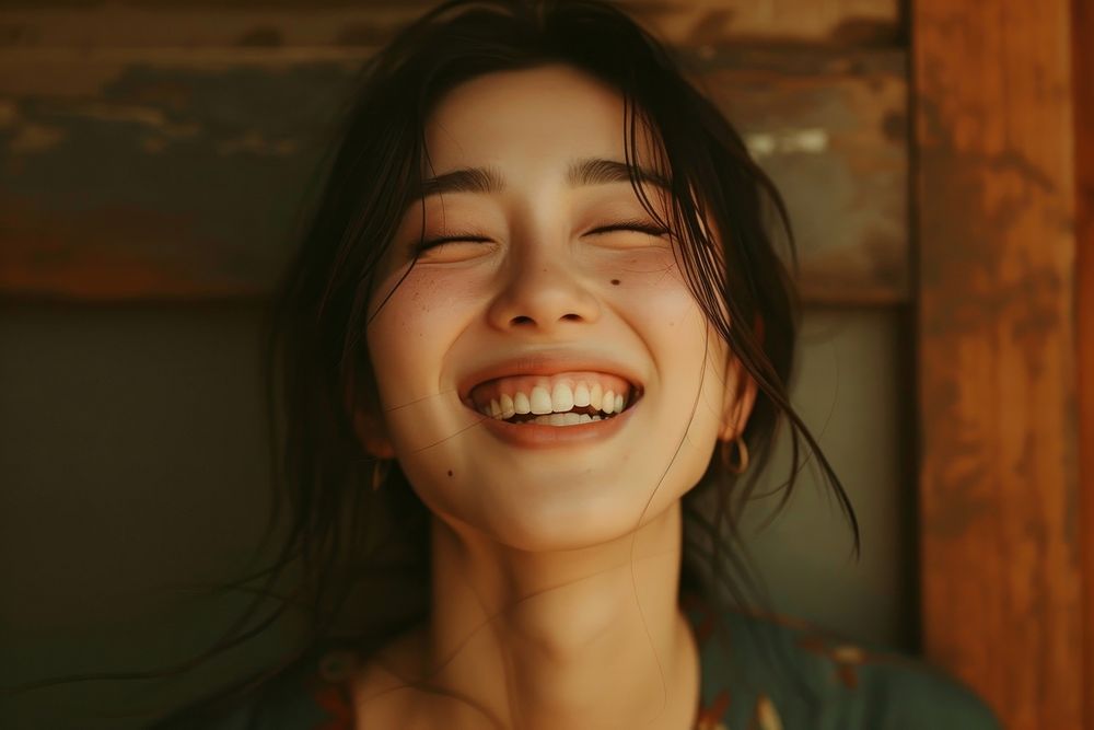 Japanese woman laughing smile eyes closed.