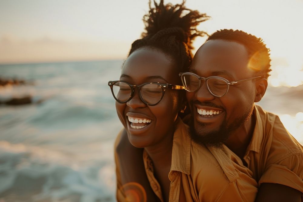 Black couple laughing portrait glasses.