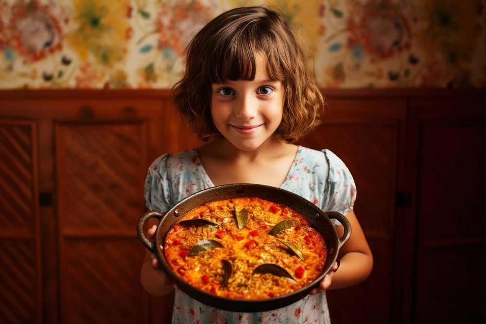 Young girl with paella food pizza child.