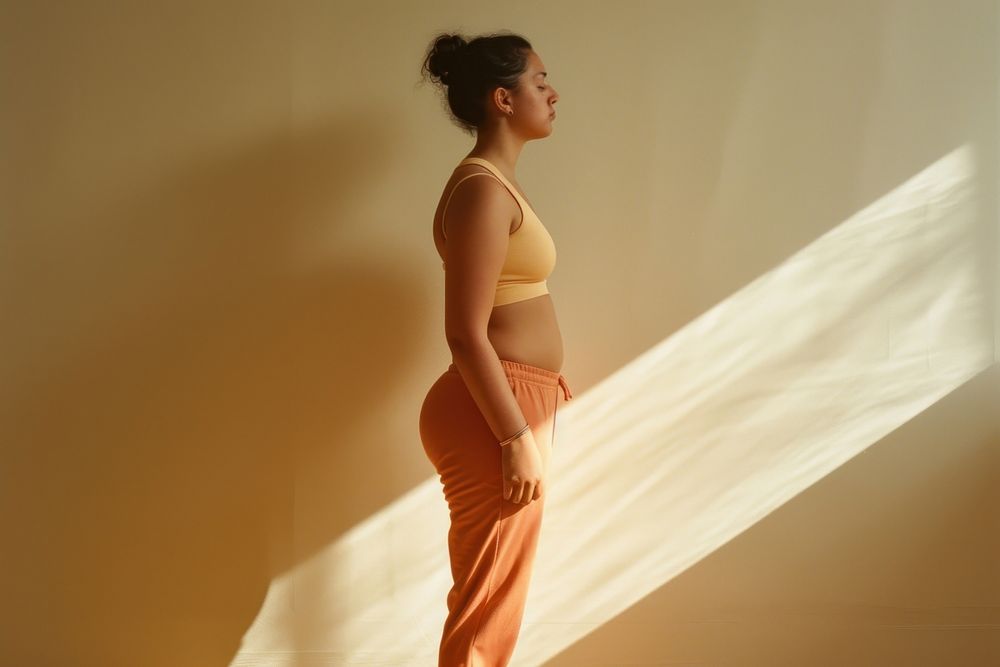 Woman standing wearing a minimal colorful outfit portrait adult yoga.