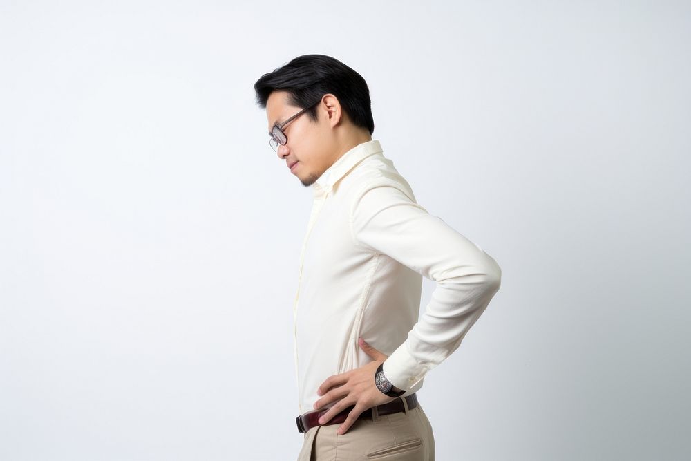 An east asian man suffering from back pain symptom portrait sleeve adult.