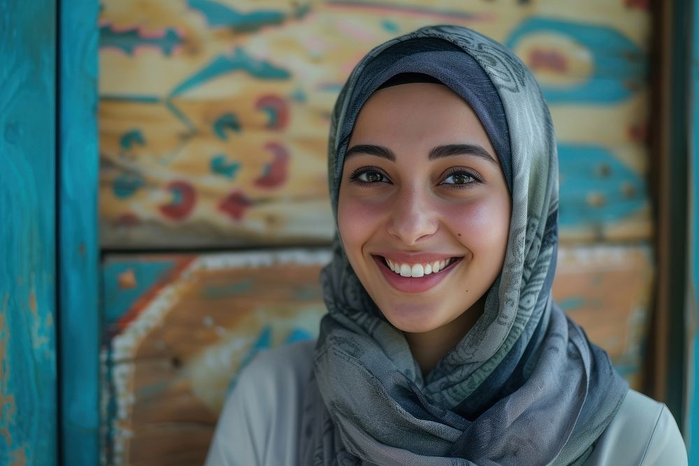 Young Muslim woman speaker on professional stage portrait smiling scarf.