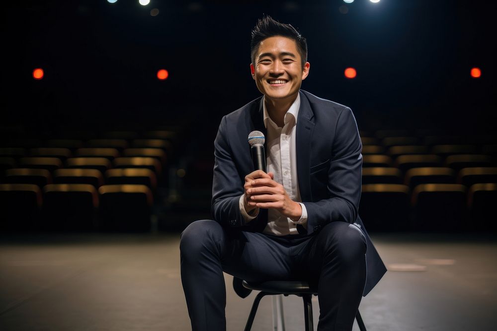 Asian man speaker on professional stage smiling sitting adult.