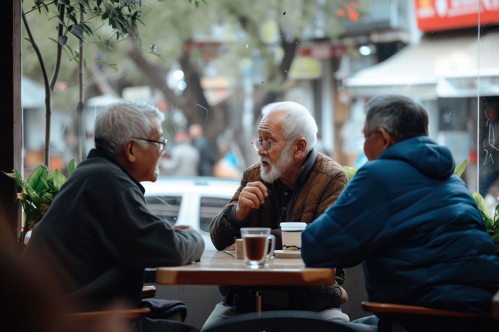 Diversity old men talk together restaurant adult table.