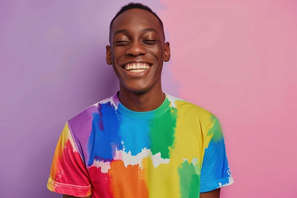 Cool LGBT young black man with fashionable clothing style full body on colored background laughing t-shirt smile.