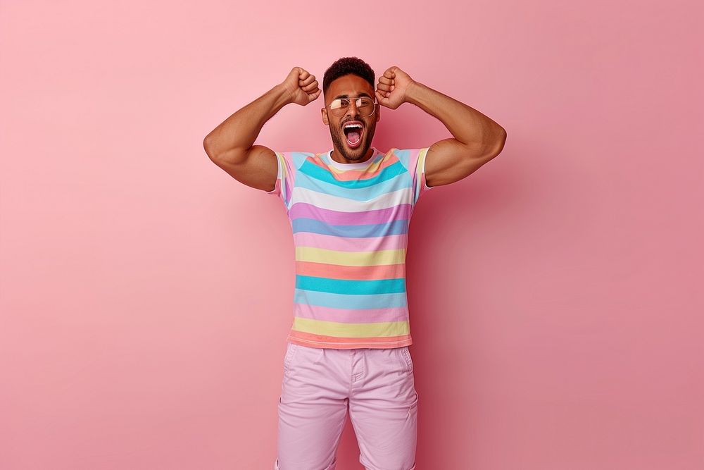 Cool LGBT young Latin man with fashionable clothing style full body on colored background shouting t-shirt adult.