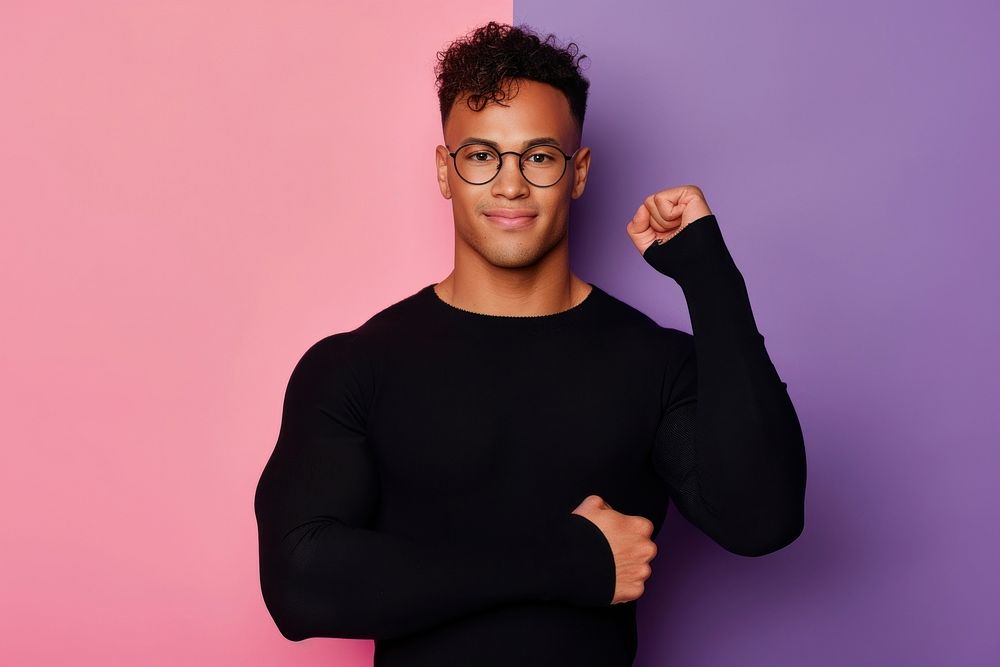 Cool LGBT young Latin man with fashionable clothing style full body on colored background portrait glasses smile.