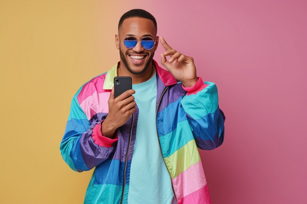 Cool LGBT young Latin man with fashionable clothing style full body on colored background selfie adult fun.