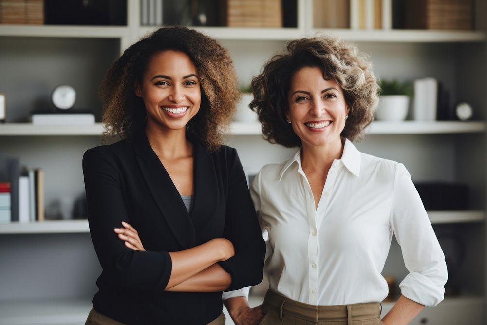 2 diverse business women smiling office adult.
