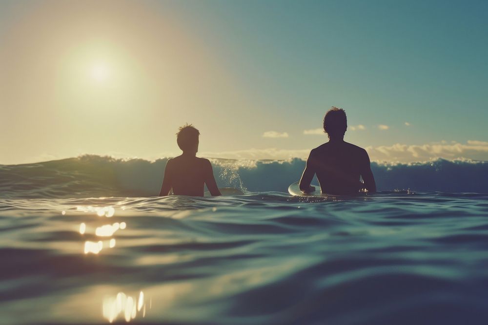 Man and friend Surfers swimming ocean outdoors.