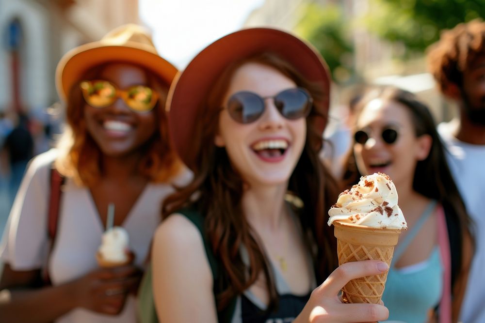 Multiethnic tourists having fun while eating an ice cream outdoors dessert glasses adult.