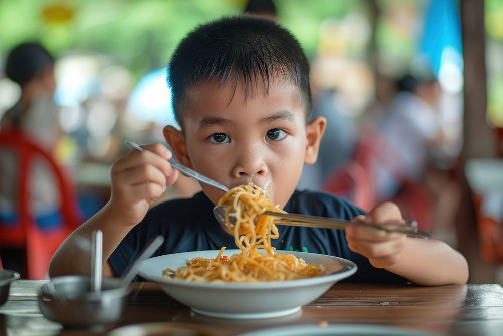 Thai boy eat noodle restaurant eating child.