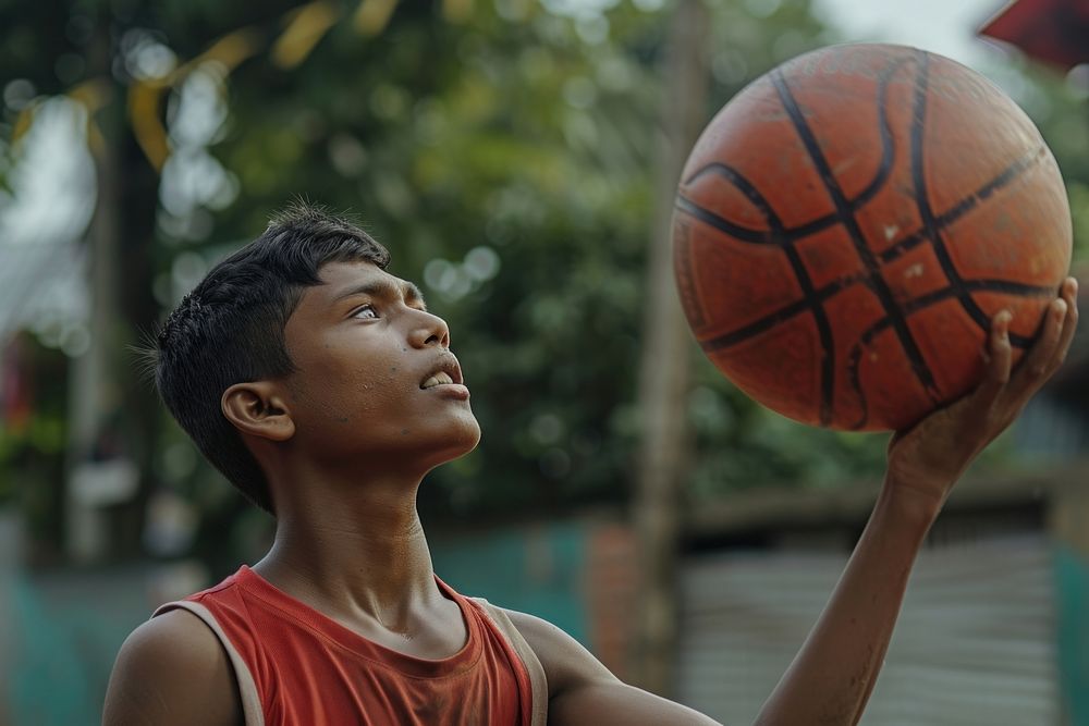 Bangladeshi young man playing sports and hobby basketball day determination.