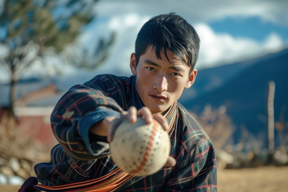Bhutanese young man playing sports and hobby photography baseball day.