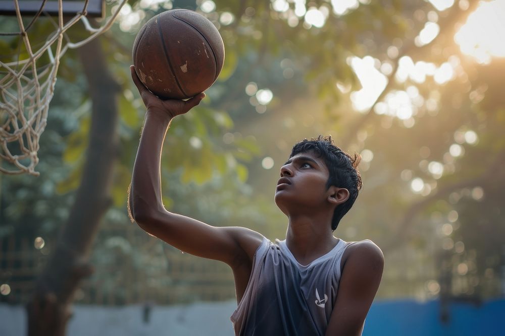 Indian young man playing sports and hobby basketball day competition.