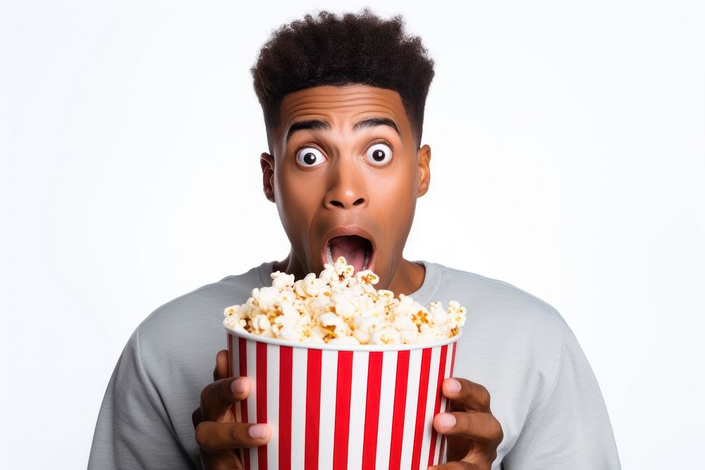 African american guy eating popcorn shock movie surprised.