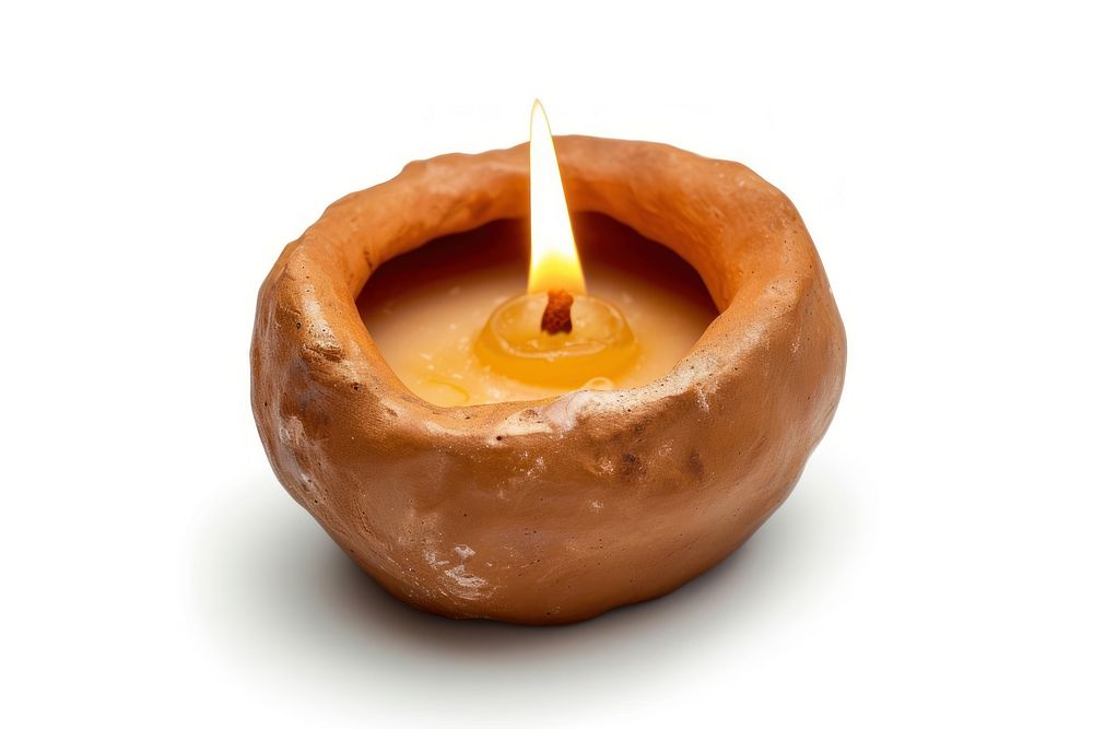 Candle made up of clay fire white background illuminated.