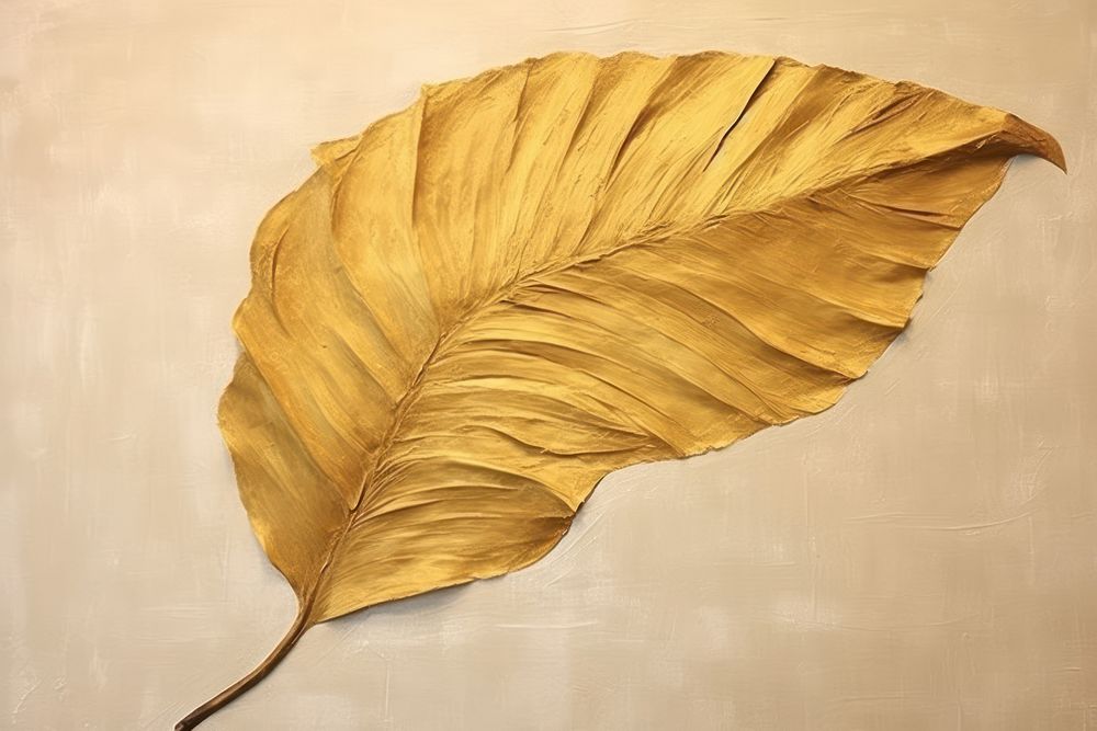Abstract gold tropical leaf ripped paper plant art textured.